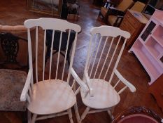 Two white stickback rocking chairs