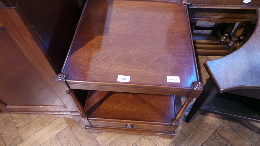A mahogany table on pair of supports with undershelf and frieze drawer, on bracket legs,