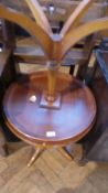 A pair of yewwood veneer circular top tripod tables by Bradley,