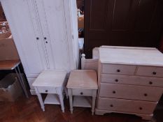 A bedroom suite of white painted pine furniture to include wardrobe, two chests of drawers,