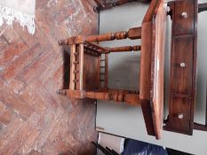 A stained oak toilet mirror with three short drawers,