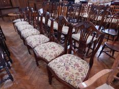 Shield-back fleur-de-lys decorated dining chairs with floral upholstered seats