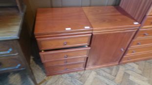 A contemporary chest of six long drawers with a matching cupboard and a small chest of drawers