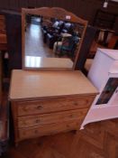 An oak mirror back dressing chest of three long drawers, with laminate top,