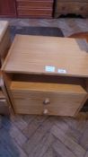 A modern pine effect small chest with open shelf and two drawers,