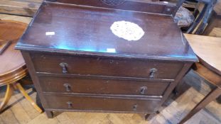 A stained oak chest of three long drawers,