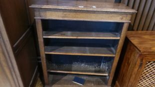 An oak open bookcase of three shelves,