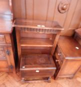 A reproduction stained oak bookcase with fluted frieze, cupboard below,
