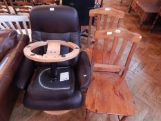 Two pine kitchen chairs together with a leather office chair and footstool