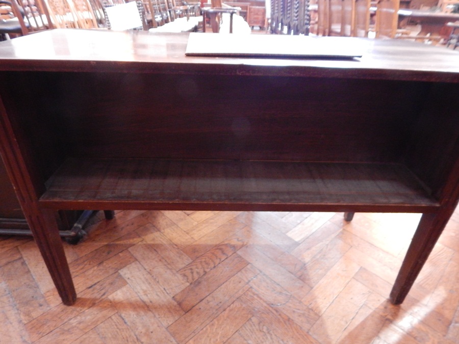 A mahogany double-sided bookcase with fluted tapering legs