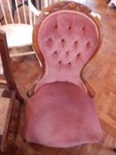 A button back chair with floral engraving,