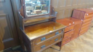 An early 20th century mahogany mirror back dressing chest, with open shelf back, two long drawers,