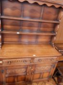 A reproduction oak dresser, with open shelf rack,