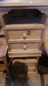 A pair of modern pine bedside chests with open shelves and two short drawers raised on plinth bases,