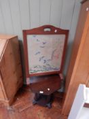 An oak firescreen with weaved oriental picture and a hexagonal oak stained side table on octagonal