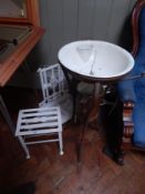 A metal wash basin on cabriole legs,