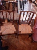 Three stickback chairs with wicker seats united by H-stretcher,