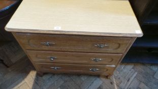 An oak chest of three long drawers, with laminate top,