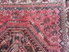 A Persian-style runner on red ground with geometric pattern, with blue guard stripe, 76cm x 123cm,