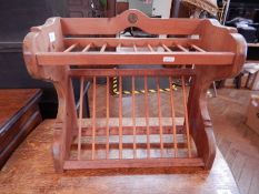 A pine magazine rack with a one pence piece set in
