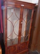 A Georgian style mahogany glazed bookcase with straight moulded cornice,