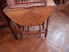 An oak Pembroke table on cylindrical and block supports