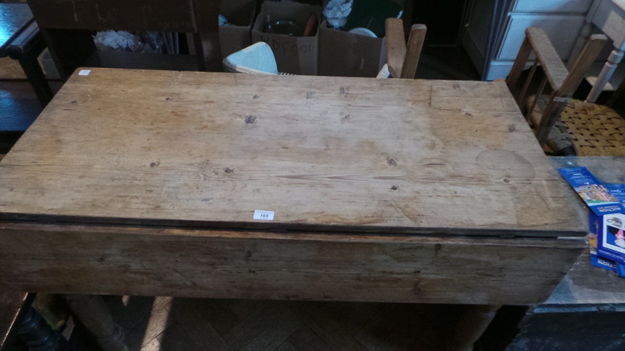 A Victorian pine dropflap kitchen table, with frieze drawer, on turned legs,