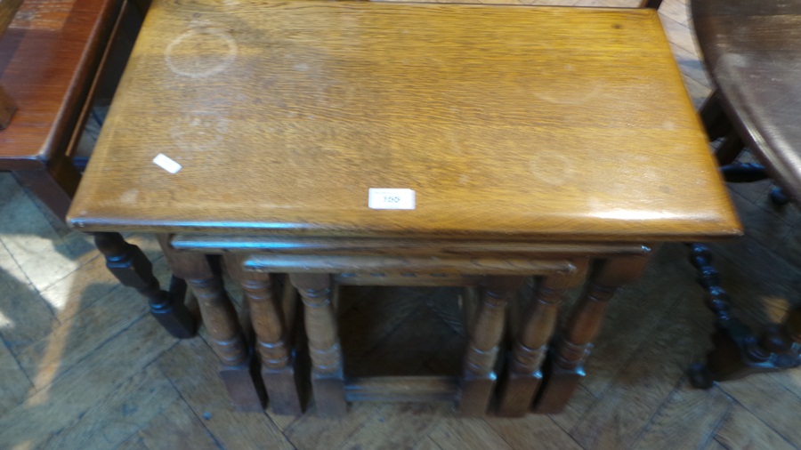 A nest of three oak occasional tables on turned legs,