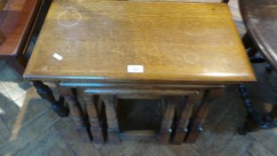 A nest of three oak occasional tables on turned legs,