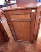 A mahogany corner cupboard, the panel door enclosing three shelves,