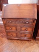 An oak bureau with fitted interior,