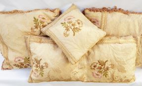 Three various cushions covered in pale pink damask with braid trimming (1 bag)
