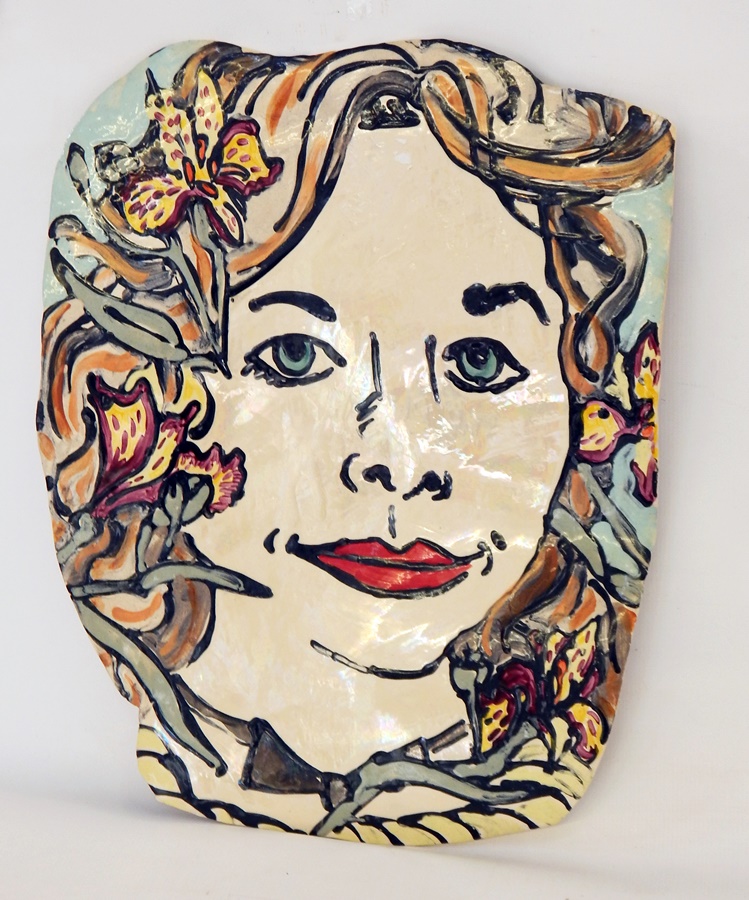 Studio pottery lustre plaque painted with the face of a woman with irises in her hair,