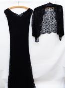 A 1950's black lace evening dress with black satin petticoat and a black lace jacket,