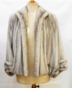 A grey mink jacket/cape labelled "Russeks",  a modern chain fastening stitched inside,