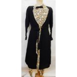 A 1940's/50's black crepe dress with floral panel, tie front, a black crepe bow, floral collar,