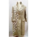 A 1950's ribbed gold opera coat with appliqued white daisies