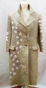 A 1950's ribbed gold opera coat with appliqued white daisies