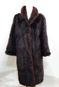 A Kenneth Stoker dark brown fur coat, possibly musquash,