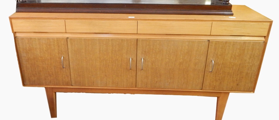 Gordon Russell sideboard with four short drawers and four under-cupboards, on tapering legs,