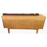 Gordon Russell sideboard with four short drawers and four under-cupboards, on tapering legs,