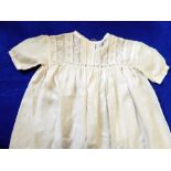 A silk christening gown trimmed with lace, another silk christening gown trimmed with lace,