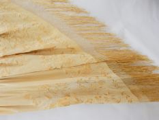 A Chinese silk apricot-coloured embroidered shawl with a deep fringe