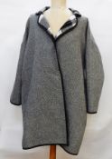 A three-quarter length wool jacket, black and white herringbone, lined with black and white check,