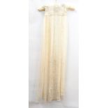 A silk and net cream-coloured christening gown,