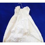 A cotton full-length baby gown with ruched bodice,