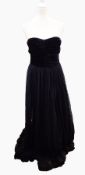 A strapless black evening gown with full lace skirt and black velvet ruched and boned bodice,