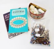 Various wooden bobbins with beads, lace collars (one undyed), books on lace making,
