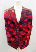 A 1980's Louise Verity patchwork waistcoat in shades of reds and blues