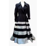 A Jasper Conran black coat dress, full skirted, the skirt banded in silver-coloured material,